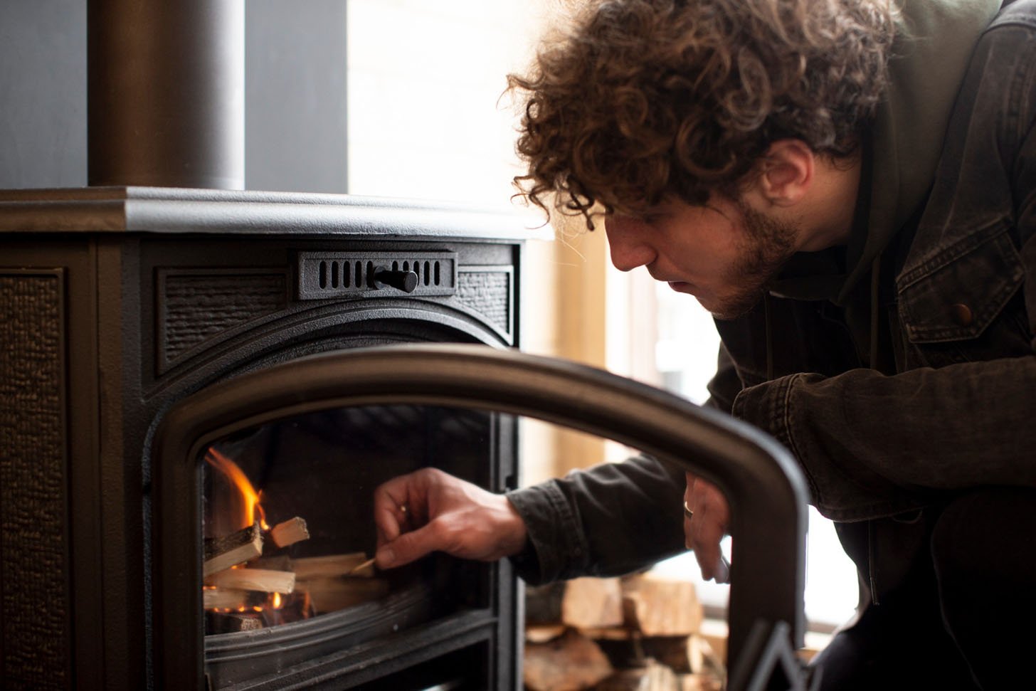 Tending a wood burning stove